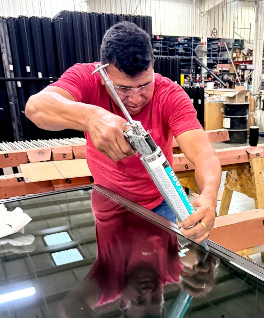 Manko worker using sealant.